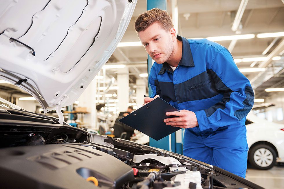 a person is inspecting the car engine